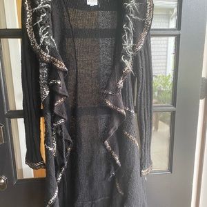 Sioni Studio small, but is a roomy, long small. I love this sweater with boots.